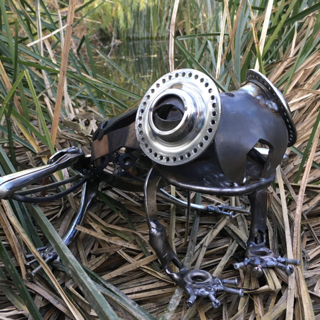 sculpture of a frog made from bike parts and tools